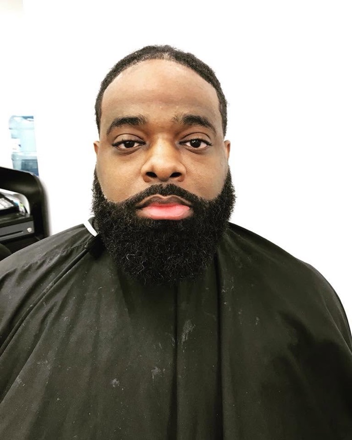 Full black beard with a sharp lineup, front view, La Barberia