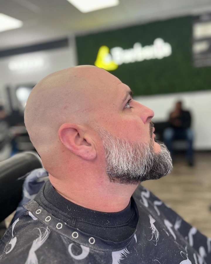 Salt-and-pepper goatee lined up clean, La Barberia