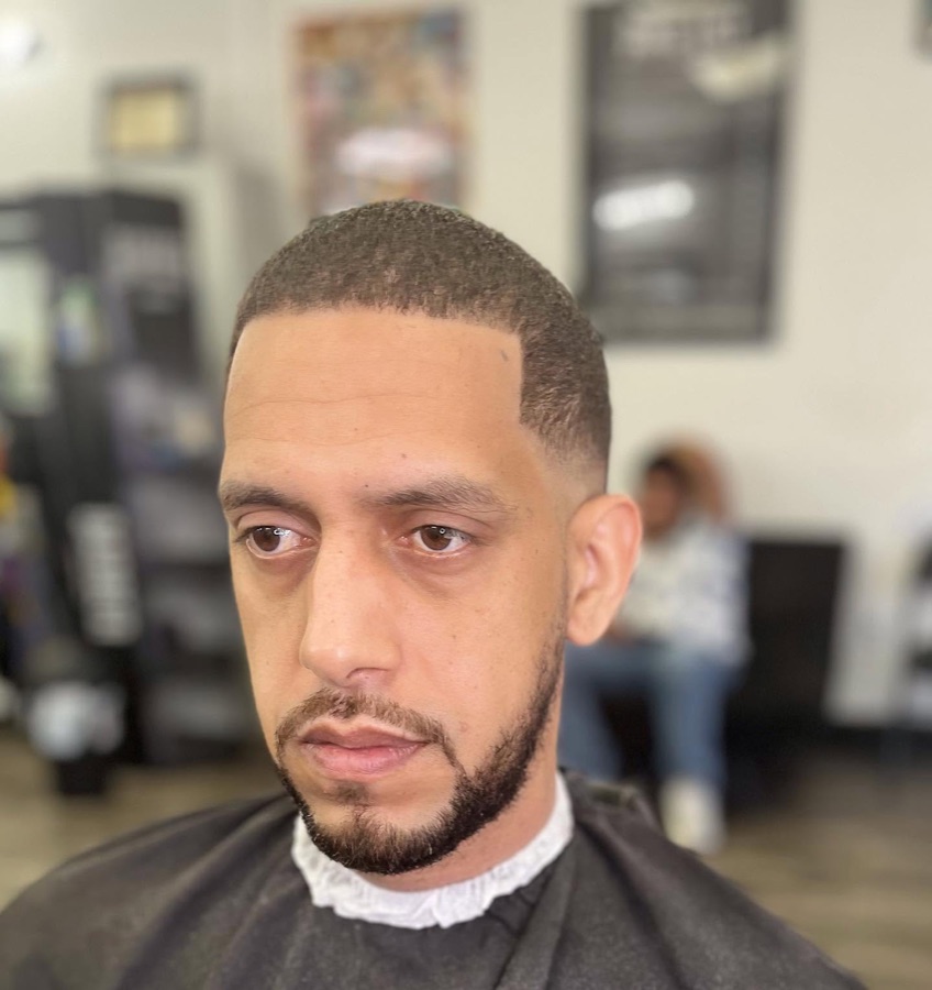 Clean full beard with a crisp lineup, La Barberia