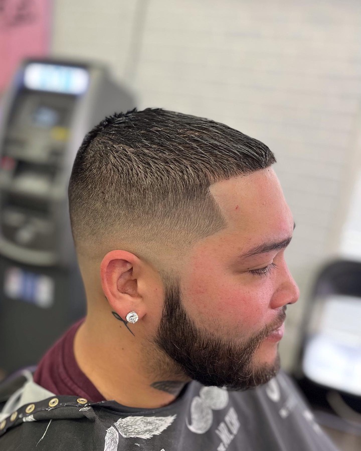 Salt-and-pepper beard with a fade, side view, La Barberia