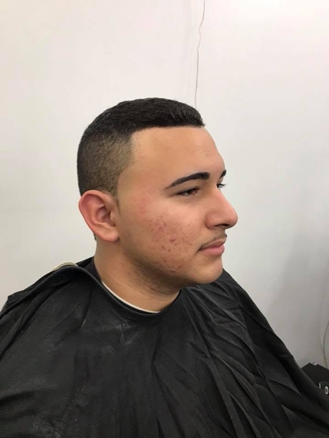 Side-profile skin fade with a lined-up beard, La Barberia