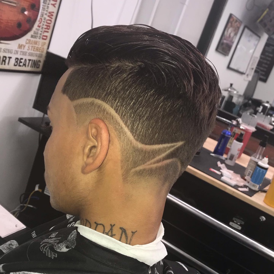 Geometric side hair design cut into a fade, La Barberia