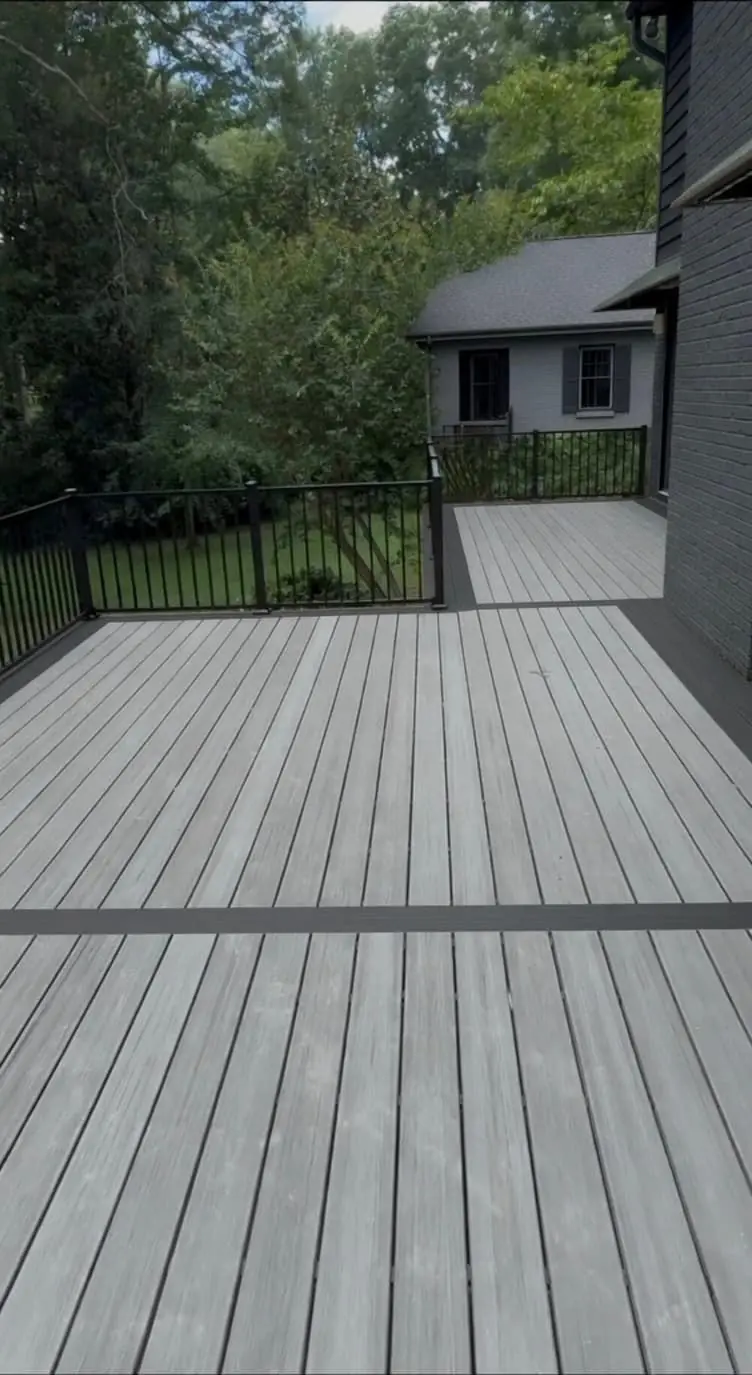 Gray composite deck with a darker picture-frame border and black rail