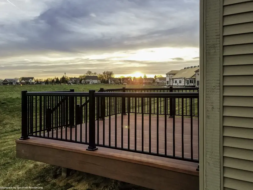 Sunspace AlumaDeck deck with a black aluminum picket railing at sunset