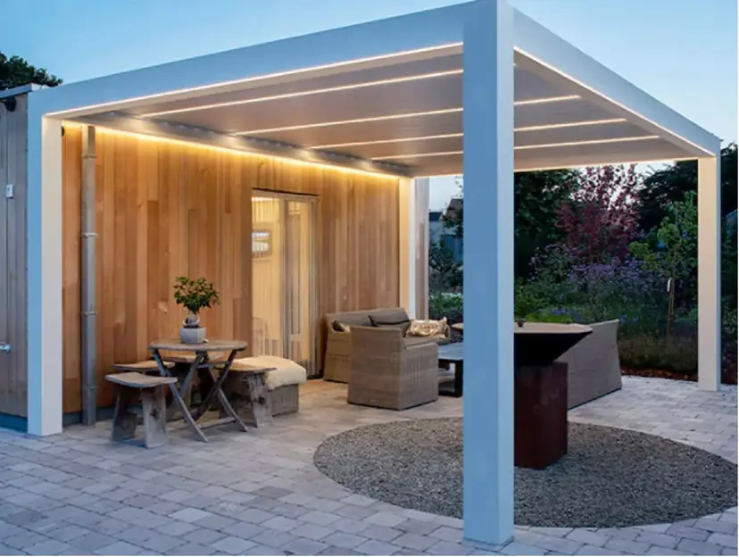 White louvered pergola with two sections joined, over a patio dining set