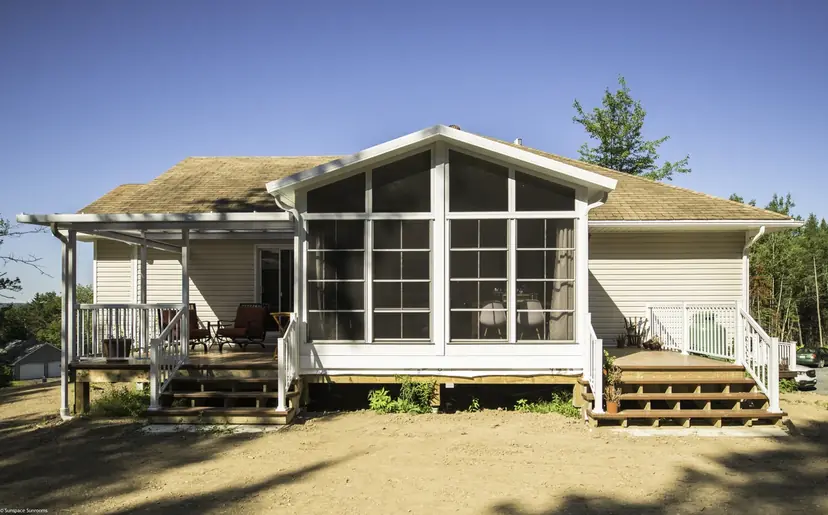 Sunspace Model 200 WeatherMaster sunroom with a gabled roof on the back of a house