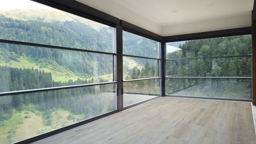 NovaSun Vertigo motorized glass wall lowered at a mountain-view terrace