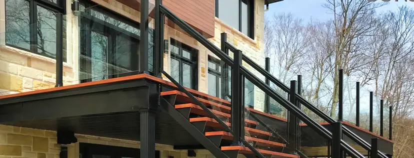 Sunspace topless glass railing beside a stair on a composite deck