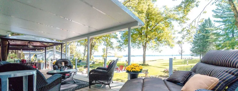 Solid insulated Sunspace patio cover over a patio with a view of the lake