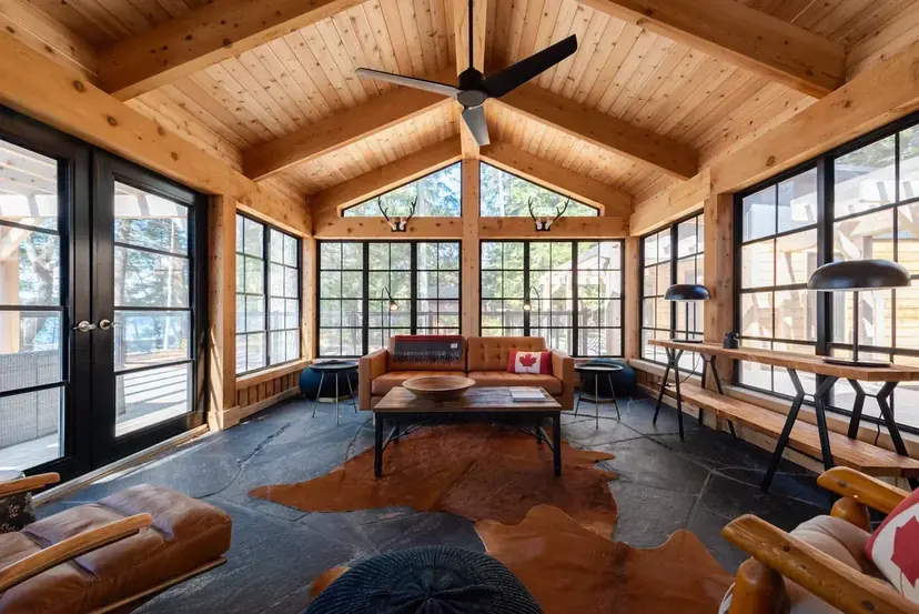 Sunspace sunroom interior with a cedar ceiling, ceiling fan and leather seating