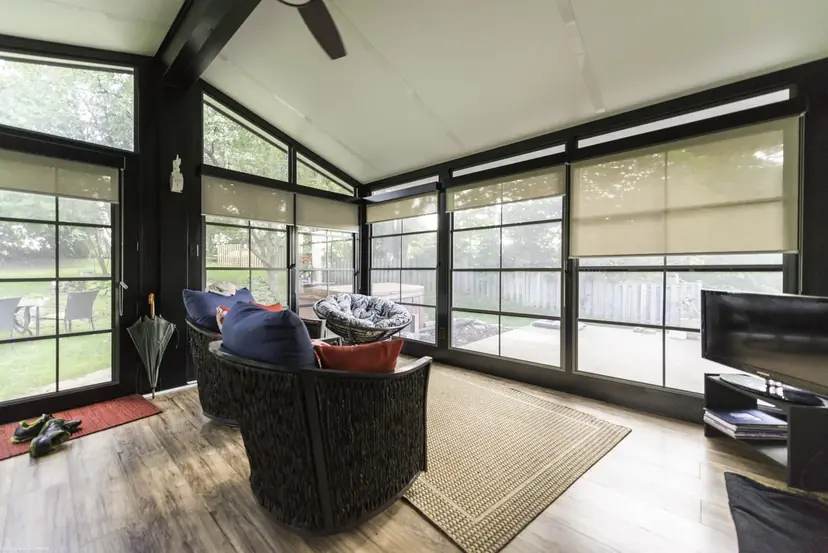 Sunspace roller sunshades half lowered in a living room
