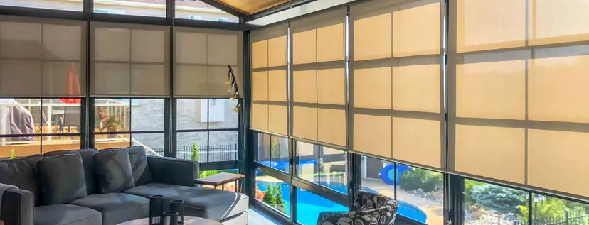 Sunspace sunshades lowered across the windows of a sunroom